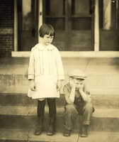 Two children on the steps of the orphanage