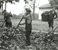 Orphanage children raking leaves