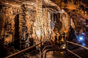 Photo of stalagmites and stalactites in a cave.
