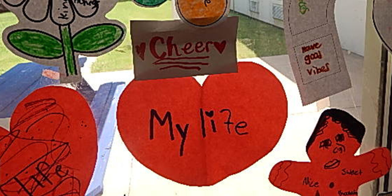 Paper cut-out shapes taped to a window